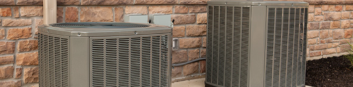 Two ac units outside of brick house